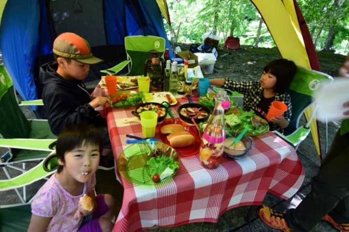 新潟県南魚沼郡にある大源太キャニオンキャンプ場でBBQを楽しむファミリー