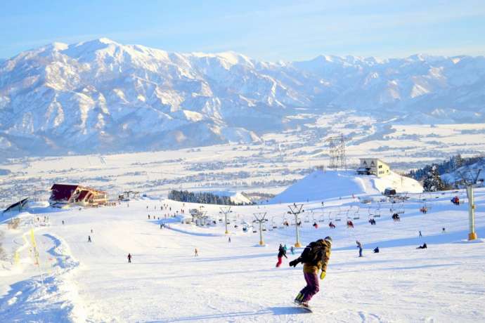 南魚沼市内のゲレンデと遠くにそびえる山々の風景