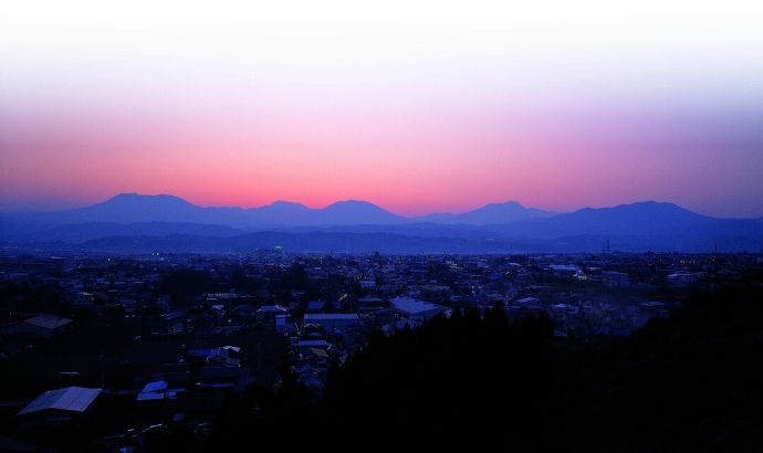 巡り逢いの丘から見える夕焼けに染まる北信五岳