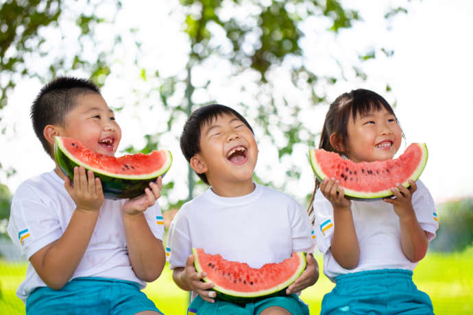 尾花沢市名産のスイカを食べる子どもたち