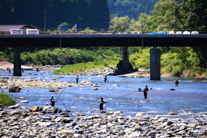 伊南川で鮎釣りをする人